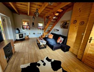 a living room with a cow rug on the floor at Alpakowy raj in Nowy Targ