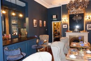 a restaurant with blue walls and a bar with chairs at The Southbank Torquay by the sea in Torquay