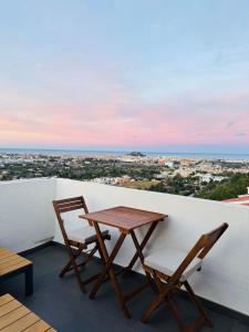 a table and two chairs on a balcony with a view at Mediterranean View Apartment in Denia