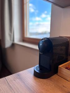 a black microwave sitting on a table in front of a window at Landhotel Bärnriegel in Mauth