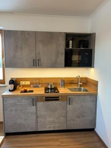 a kitchen with a sink and a counter top at Landhotel Bärnriegel in Mauth