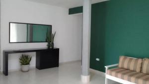a living room with a television and a couch at Hotel Dieux Internacional in Pedernales