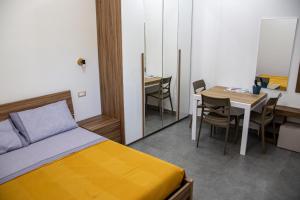 a bedroom with a bed and a table with chairs at Case Vacanze Marinella in Viverone