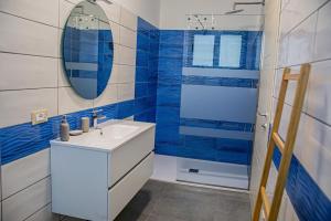 a bathroom with a sink and a mirror at Case Vacanze Marinella in Viverone +7 photos