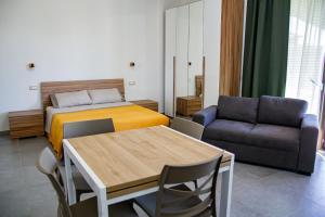 a bedroom with a bed and a table and a couch at Case Vacanze Marinella in Viverone