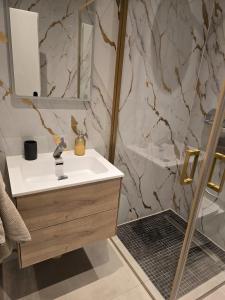 a bathroom with a sink and a mirror at Marlin City Apartment Erdgeschoss 1 in Bielefeld
