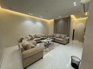 a living room with couches and a table at الشقق الفاخرة luxury aparments in Medina