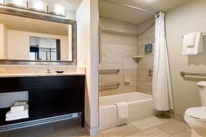 a bathroom with a tub and a sink and a toilet at Aspen Select in Rochester +8 photos
