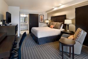 a hotel room with a bed and a living room at Aspen Select in Rochester