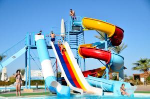 a water slide at a resort with people on it at Queen Sharm Aqua Park Hotel in Sharm El Sheikh