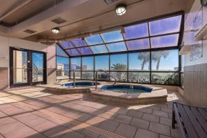 a large room with two pools and a large window at Phoenix East 808 in Orange Beach