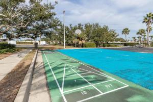 a basketball court is painted blue and green at Phoenix East 808 in Orange Beach +17 photos