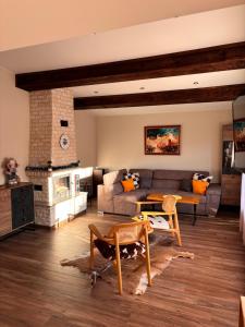 a living room with a couch and a table at Вила Рафаела-Мартина in Dobrinishte