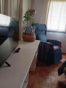 a living room with a table and a chair at Casa Boreal dptos estilo casa in Puerto Madryn +53 photos