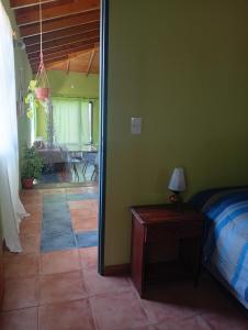 a bedroom with a bed and a table with a lamp at Casa Boreal dptos estilo casa in Puerto Madryn