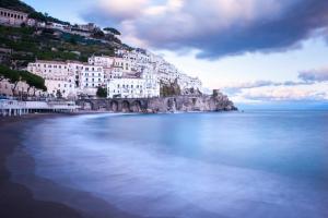 a view of a beach with buildings on a hill at Casa Alfonso in Minori