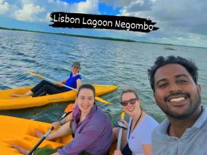 a group of people on kayaks on the water at Lisbon Lagoons in Negombo +3 photos