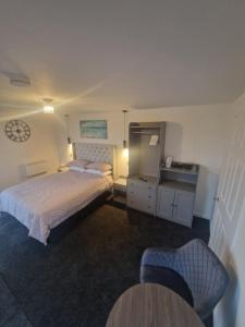 a hotel room with two beds and a sink at THE COASTAL INN ACCOMMODATIONs in Cellardyke
