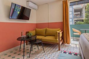 a living room with a couch and a table at Hotel San Fernando in Mexico City