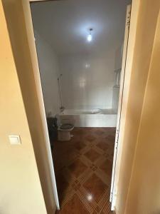 a bathroom with a toilet and a tub in a room at Home Lenda in Tarrafal +14 photos