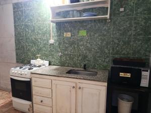 a kitchen with a sink and a stove at Verde limón in Olavarría