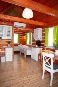 a kitchen with white cabinets and a table and chairs at Apartmany Silver in Rokytnice nad Jizerou