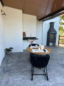 a dining room with a table and a fireplace at Kabana Harmony in Aquidauana