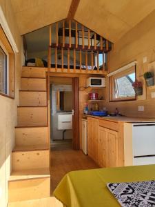 a small kitchen with a staircase in a tiny house at maison du bonheur in Tréflez