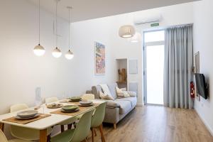 a living room with a table and a couch at Main Lofts Valencia in Valencia +100 photos