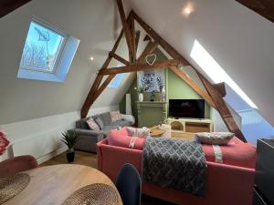 a living room with a couch and a table at Appart CATHEDRALE in Saint-Omer