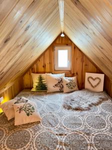 a room with a bed in a wooden cabin at Apartmany Silver in Rokytnice nad Jizerou