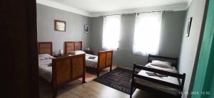 a bedroom with two beds and a window at Domaći Berek in Hlebine
