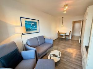 a living room with a couch and a table at Wiking, App 201A in Westerland