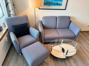 a living room with two chairs and a table at Wiking, App 201A in Westerland