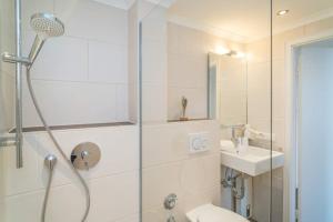 a bathroom with a shower and a sink at Sylter Residenz, App 56 in Westerland