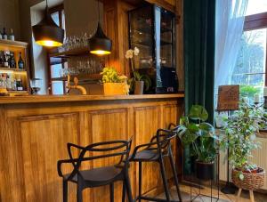 a bar with two chairs and a counter in a restaurant at Hotel i Restauracja Castle in Bystrzyca Kłodzka