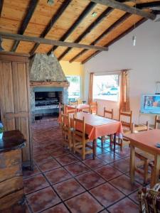 a dining room with a table and a fireplace at Cabañas Dolce Far Niente in Tandil