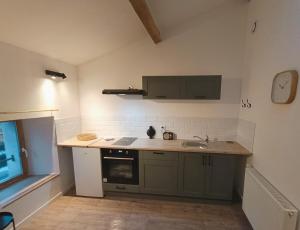 a kitchen with a sink and a counter top at Agréable studio privé avec terrasse in Olliergues +11 photos