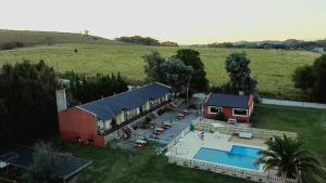an aerial view of a house with a swimming pool at Cabañas Dolce Far Niente in Tandil