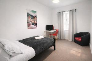 a bedroom with a bed and a chair and a desk at BEST DEAL - Kings Hotel in Blackburn