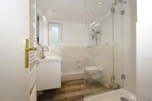 a bathroom with a toilet and a sink and a shower at Brönswai 5B in Westerland +15 photos