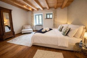 a bedroom with a large white bed and a window at Aurisina heart apartment in Aurisina