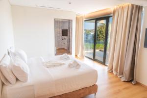 a bedroom with a bed and a large window at Megara Hotel in Megara +25 photos