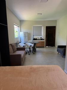 a living room with a couch and a table at Tiny House Campeche - Vista do Lampião in Florianópolis