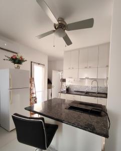 a kitchen with a ceiling fan and a counter top at על הים in Nahariyya