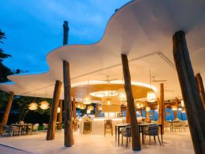 a restaurant with tables and chairs under a white tent at SO/ Sofitel Hua Hin in Cha Am +134 photos