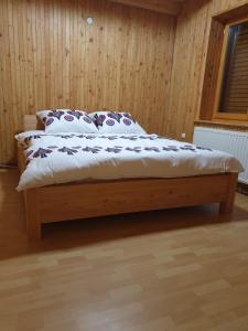 a bed with two pillows on it in a room at Leśna Przystań in Sidzina