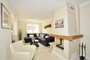 a living room with a couch and a fireplace at Ferienhaus Litj Stig in Westerland
