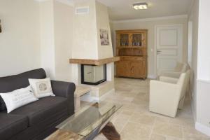 a living room with a couch and a fireplace at Ferienhaus Litj Stig in Westerland +30 photos