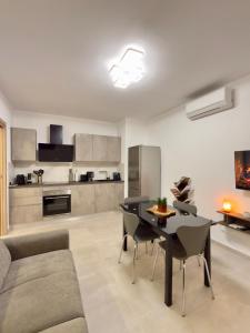 a kitchen and living room with a table and chairs at Casa Alpea in Villadossola